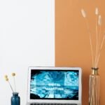 Sleek laptop displaying digital marketing on a stylish minimalist desk with modern decor.